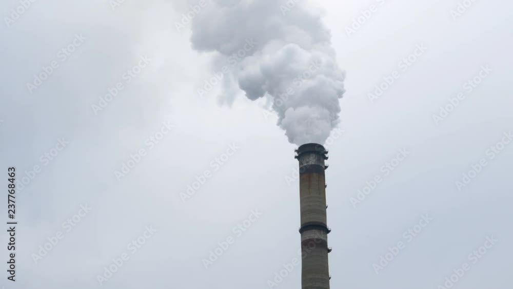 Atmospheric air pollution from industrial smoke and dioxide. Pipe smoke and steam of thermal station. Works in cloudy day. Environmental pollution. Atmospheric air pollution from industrial smoke and dioxide. Pipe smoke and steam of thermal station. Works in cloudy day. Environmental pollution.