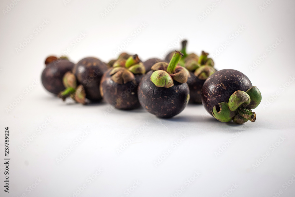 Isolated mangosteens. Plenty fruits isolated on white background Isolated mangosteens. Plenty fruits isolated on white background