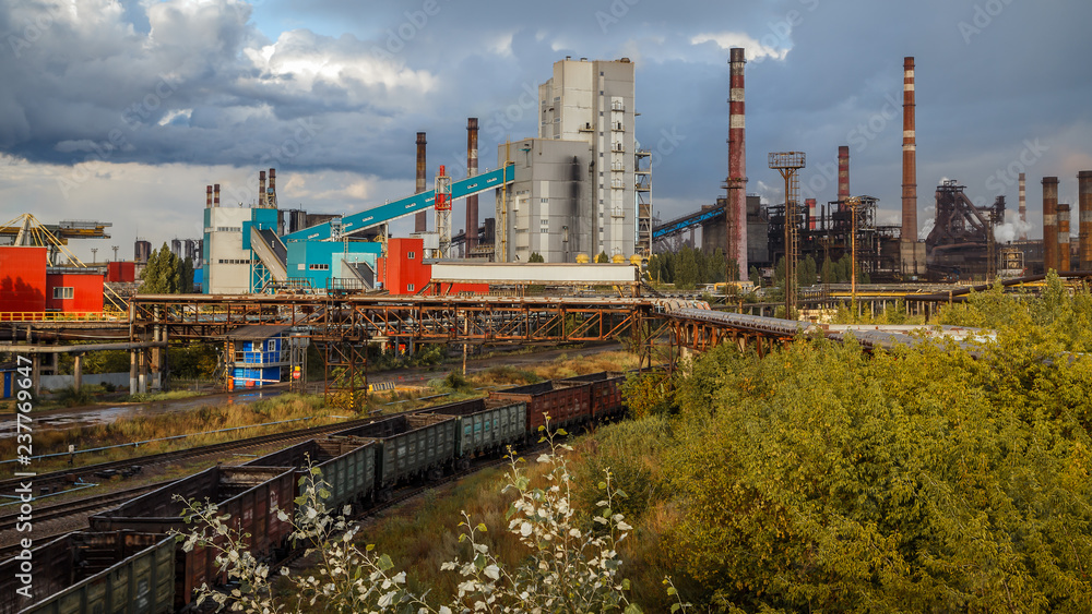 Industrial landscape. Industrial plant and railroad before the thunderstorm.