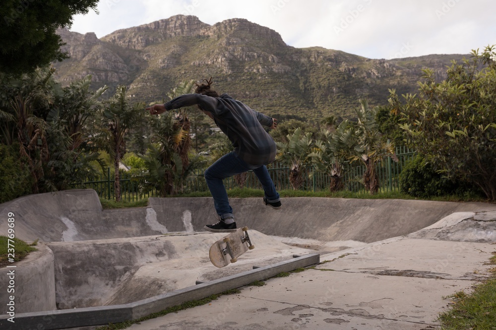 Man skateboarding at skateboard park Man skateboarding at skateboard park