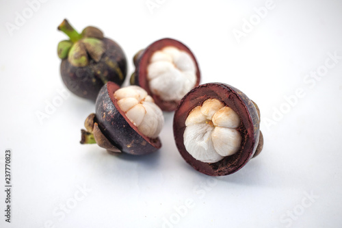 Isolated mangosteens. Four cutted fruits isolated on white background