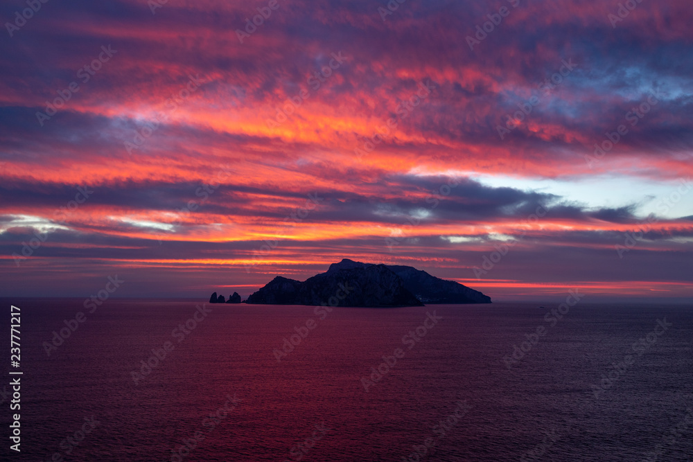 Capri at sunset seen from Punta Campanela, Sorrento Peninsula, Italy Capri at sunset seen from Punta Campanela, Sorrento Peninsula, Italy