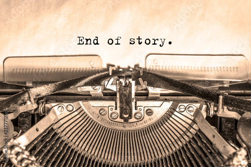 end of story printed on a piece of paper on a vintage typewriter. writer, journalist.