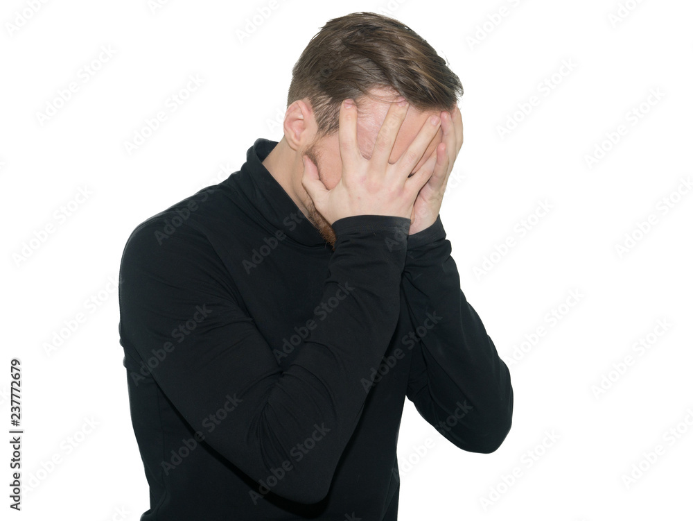 Portrait of despair young man closed face by two hands. Isolated on a white background. Portrait of despair young man closed face by two hands. Isolated on a white background.