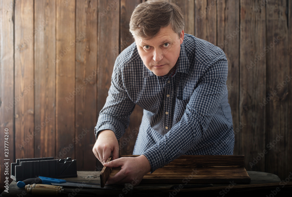 carpenter working with tools on wooden background carpenter working with tools on wooden background
