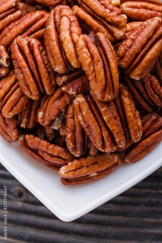 delicious pecan nuts on a rustic wooden background delicious pecan nuts on a rustic wooden background