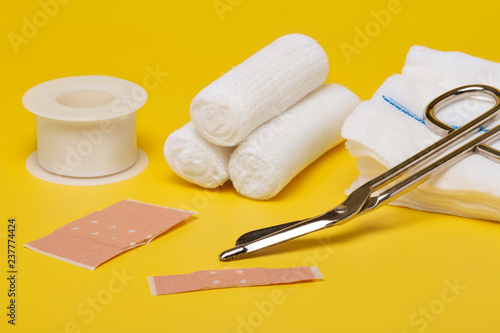 Plaster bandage roll and scissors