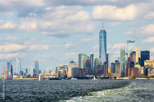 Manhattan skyline with One World Trade Center and surrounding buildings viewed from the waters of The Upper New York Bay