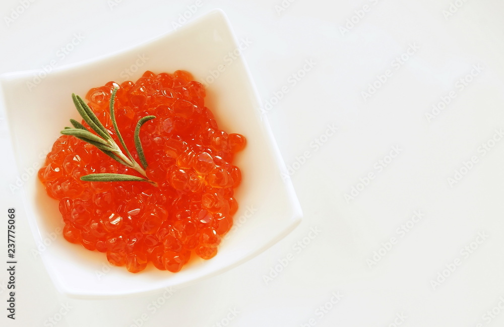 red caviar in small bowls on white background. top view.copy space