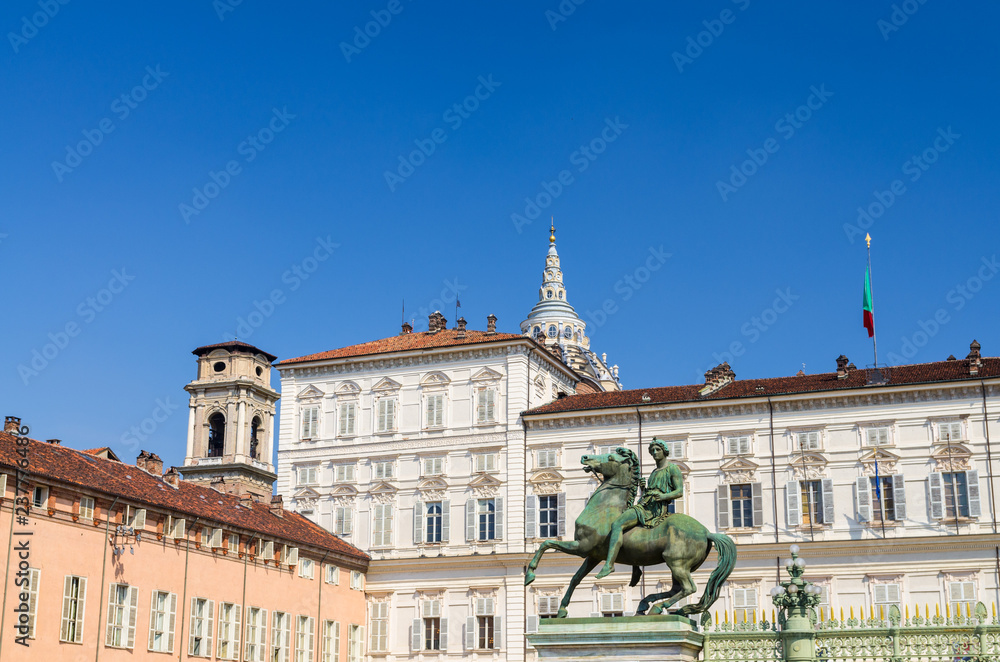 Statua equestre di Polluce monument in front of Royal Palace Palazzo Reale white building on Castle Square Piazza Castello in historical centre of Turin Torino city, clear blue sky, Piedmont, Italy