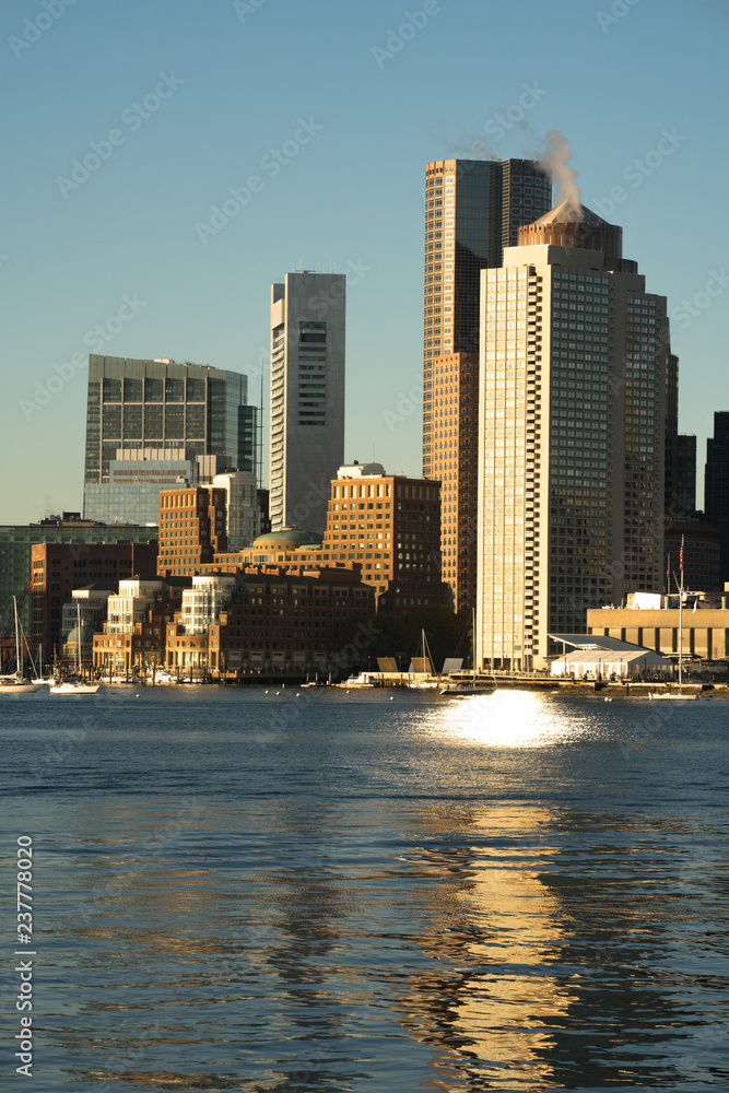 Obraz premium Sunrise on the architecture and waterfront of the urban city skyline of Boston MA