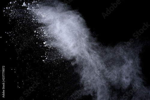 White powder explosion on black background. Colored cloud. Colorful dust explode. Paint Holi. © wooddy7