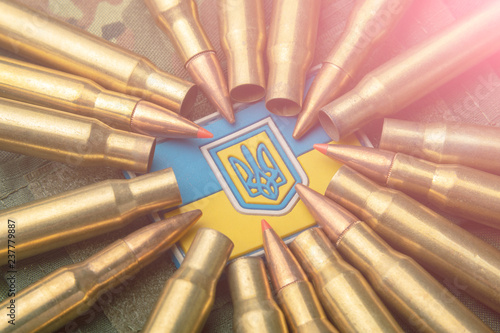 combat bullets on the background of the Ukrainian flag. Camouflage symbol of the Ukrainian army photo