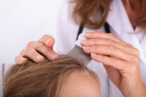 Doctor Examining Girl's Hair