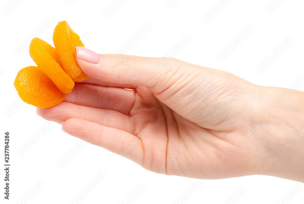 Dried apricots in hand on white background isolation Dried apricots in hand on white background isolation