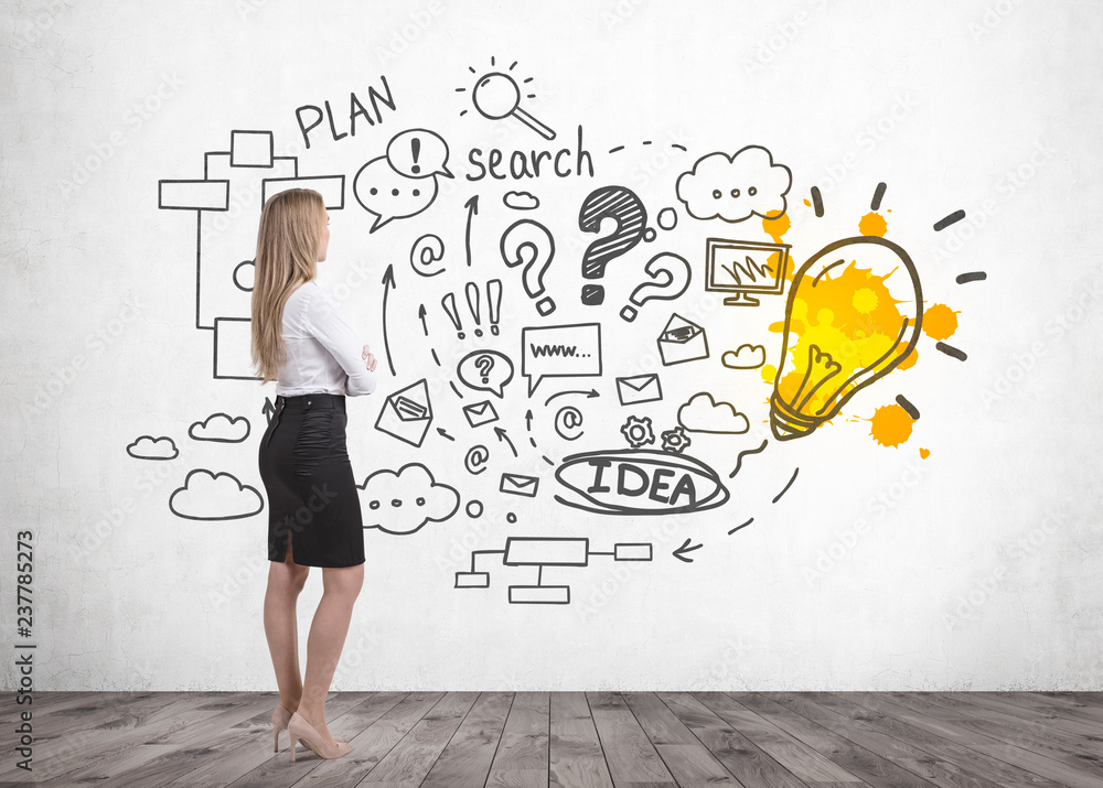 Businesswoman looking at business plan drawing Businesswoman looking at business plan drawing