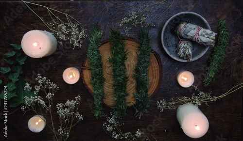 Evergreen cleansing sticks for Yule winter solstice Christmas celebration. Different types of smoke cleanings bundles made from fir, cedar. Alternatives form sage smudge sticks on dark wooden table
