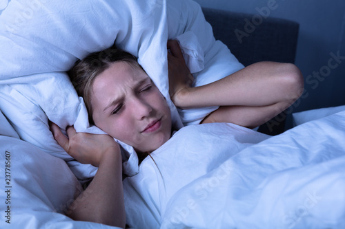 Girl Covering Her Ear With Pillow