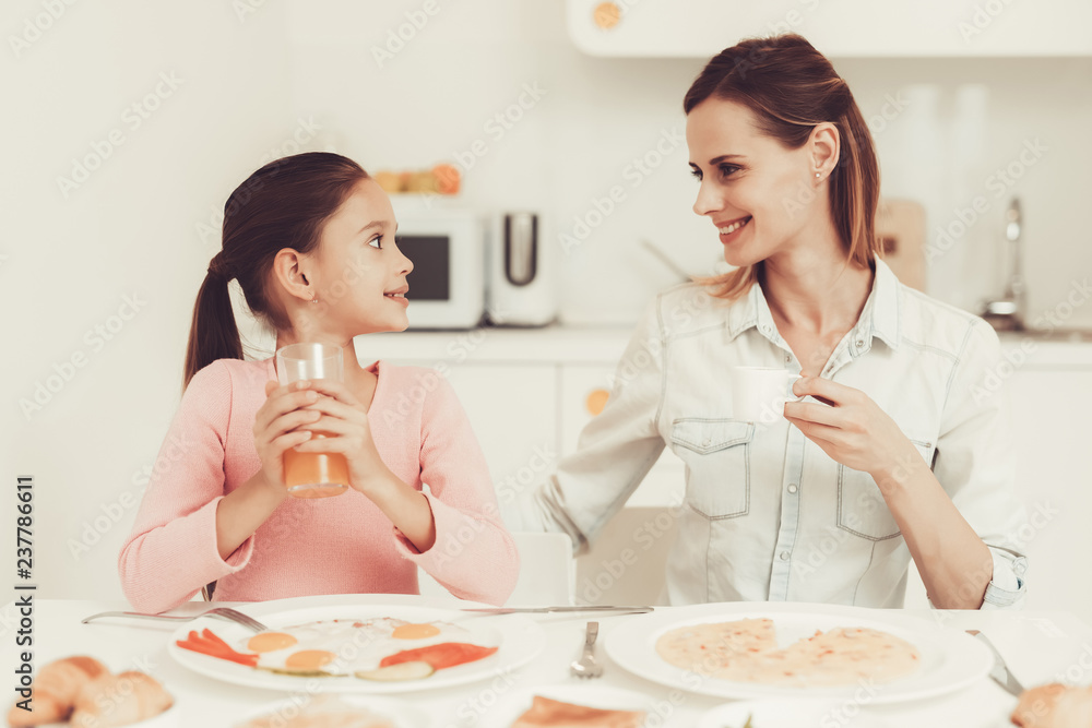 Mom With Daughter Are Having A Dinner At Kitchen. Mom With Daughter Are Having A Dinner At Kitchen.
