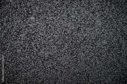 Textured abstract view of fresh new flattened asphalt in a full frame close up background