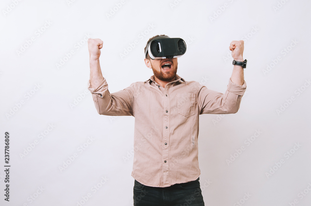 Young hipster bearded man winning in virtual game Young hipster bearded man winning in virtual game