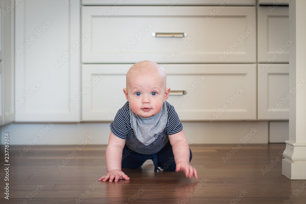 infant crawling on kitchen floor infant crawling on kitchen floor