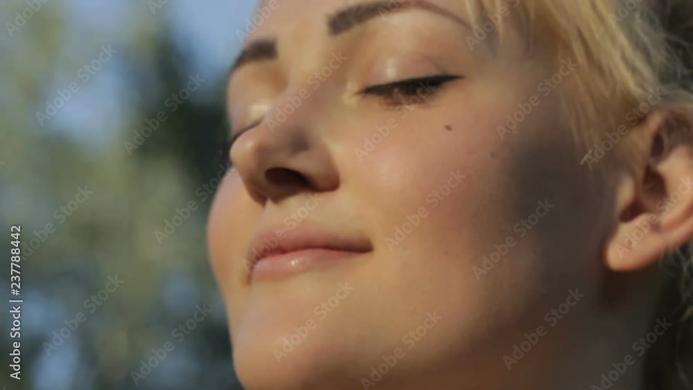 Attractive woman standing outside, enjoying, easy wind awesome weather, dreaming Attractive woman standing outside, enjoying, easy wind awesome weather, dreaming