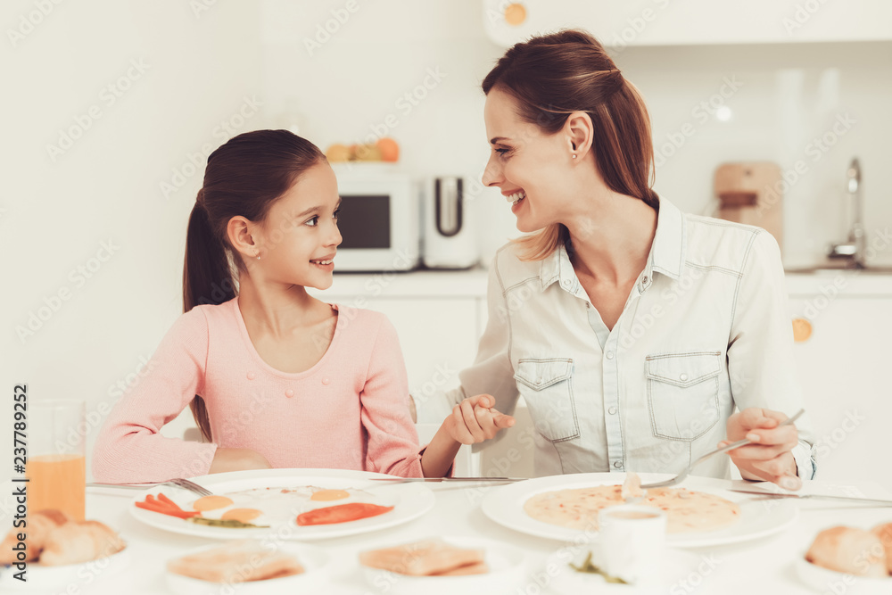 Mom With Daughter Are Having A Dinner At Kitchen. Mom With Daughter Are Having A Dinner At Kitchen.