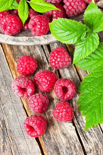 Fresh organic fruit - raspberry on wooden background