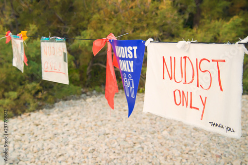 nudists only hand made sign on beach