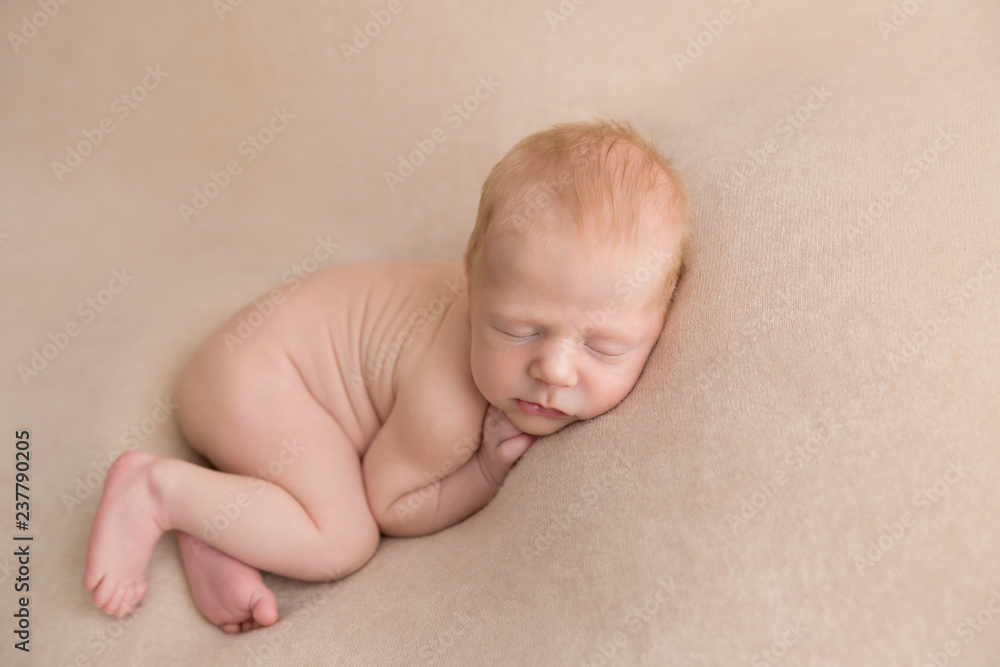 newborn child. little boy. newborn on a beige blanket. first photo shoot newborn child. little boy. newborn on a beige blanket. first photo shoot