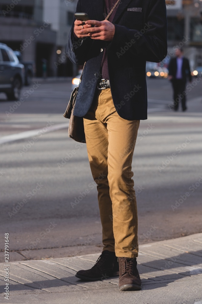 Man using mobile phone while walking on the street Man using mobile phone while walking on the street