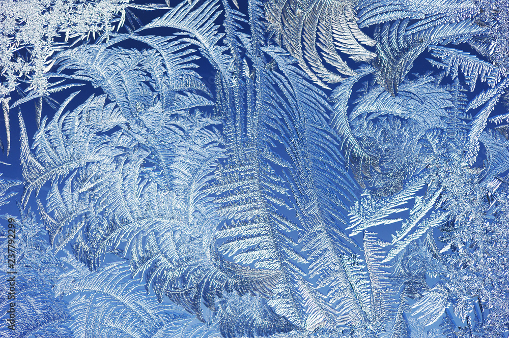 Winter background, frost and ice crystals on window.