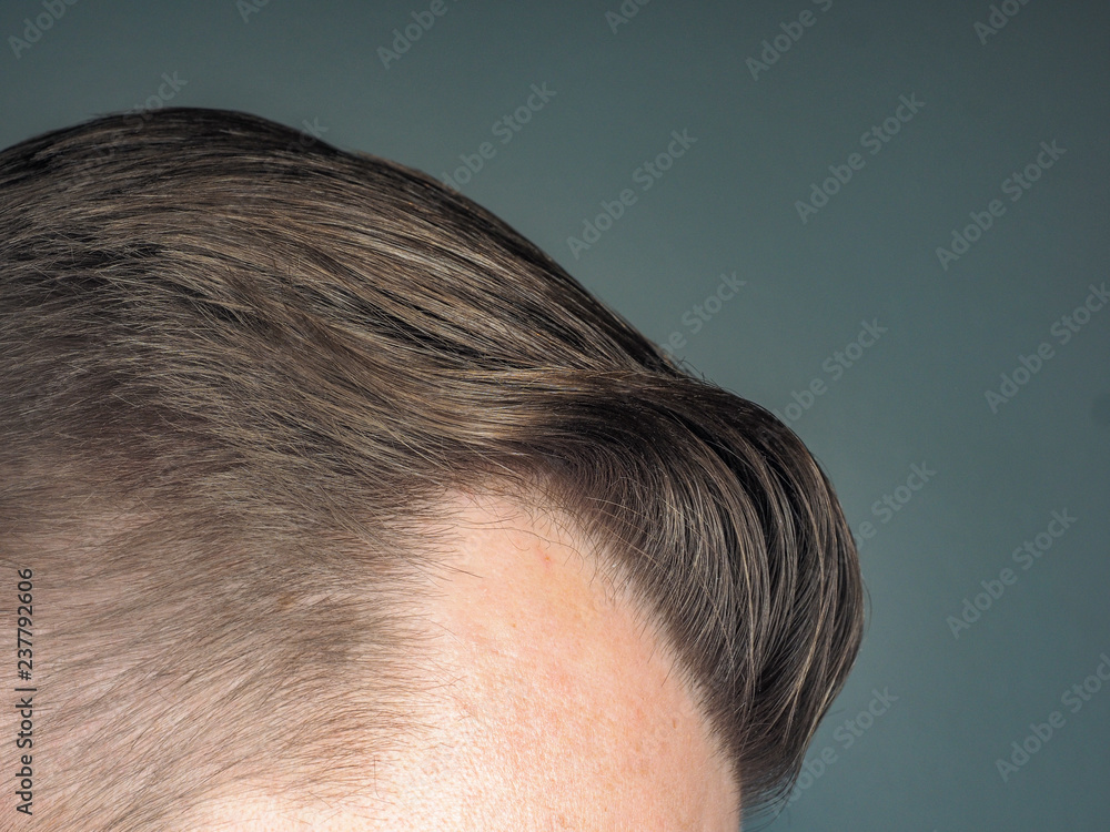 Pulled back hair style on unrecognizable male, towards gray Pulled back hair style on unrecognizable male, towards gray