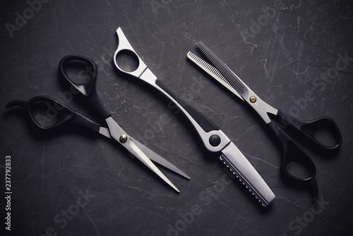 Hairdressing tools on black background with copy space at top