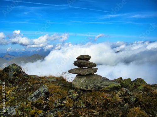 View from mountain range to the valley above fog and clouds