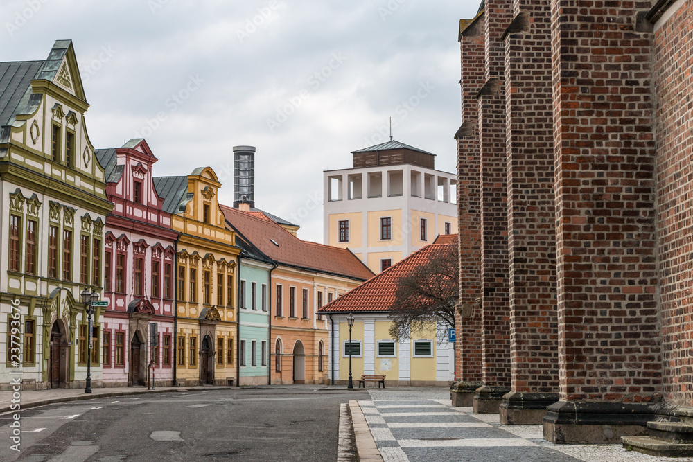 Colorful houses of Hradec Kralove city center. Beautiful czech cityscape with decorated buildings and red brick cathedral wall.