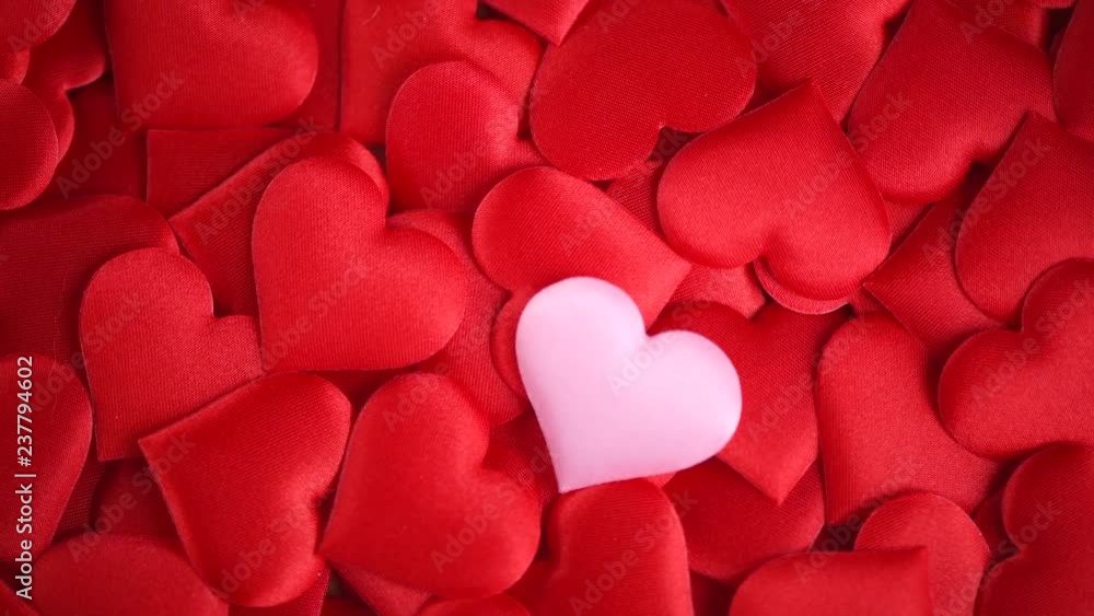Valentine's Day. Holiday abstract red Valentine background with satin hearts. Rotated heart shape backdrop. 4K UHD video footage. 3840X2160 Valentine's Day. Holiday abstract red Valentine background with satin hearts. Rotated heart shape backdrop. 4K UHD video footage. 3840X2160