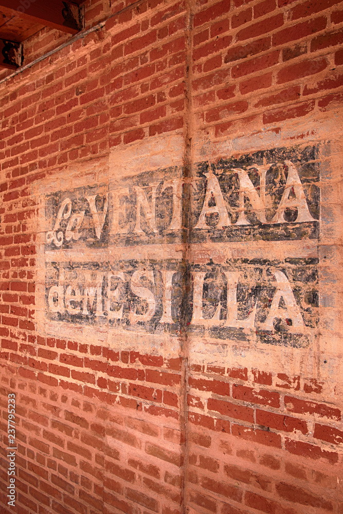 La Ventana de Mesilla painted sign on a brick wall in Las Cruces NM