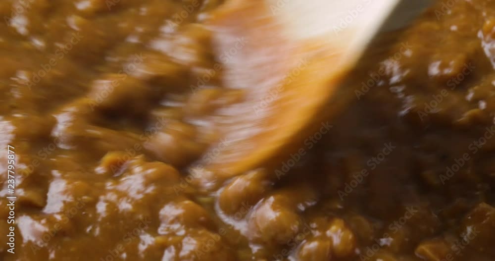 Very close video of stirring then taking a spoonful of chickpea soup with potatoes onions in a tomato sauce in a pan while cooking with a wood spoon. Very close video of stirring then taking a spoonful of chickpea soup with potatoes onions in a tomato sauce in a pan while cooking with a wood spoon.