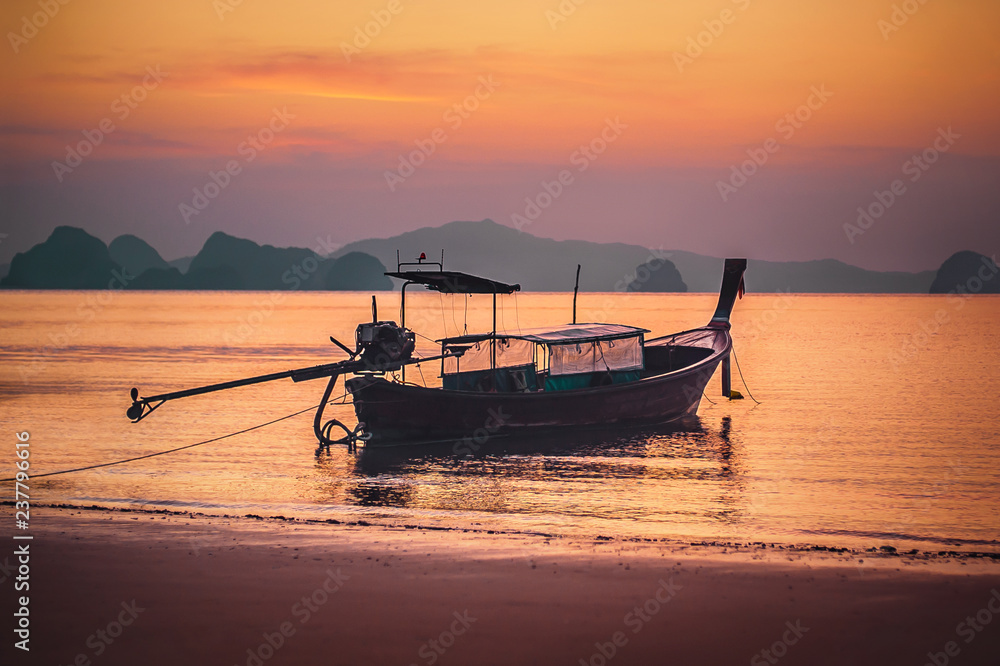 Traditional long tail boat in sunset at koh Hong island