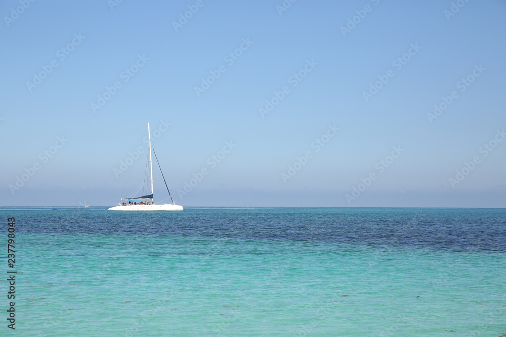 white yacht in blue sea on blue sky background without clouds. Summer concept background - Sea or Ocean Beach. With copy space for text or image. Wallpaper, postcard