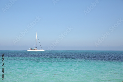 white yacht in blue sea on blue sky background without clouds. Summer concept background - Sea or Ocean Beach. With copy space for text or image. Wallpaper, postcard