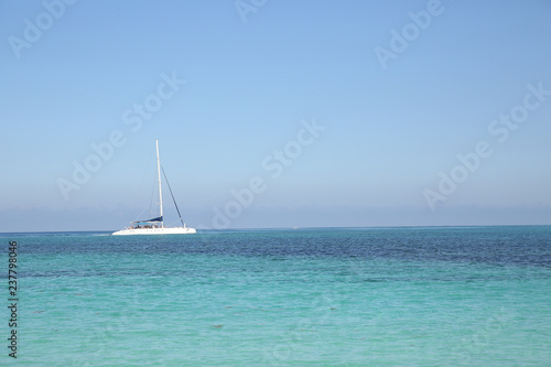 white yacht in blue sea on blue sky background without clouds. Summer concept background - Sea or Ocean Beach. With copy space for text or image. Wallpaper, postcard