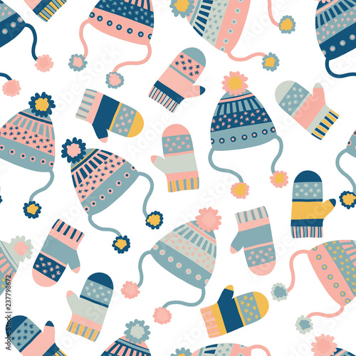 Seamless vector background with hats and mittens. Pattern tile with knitted winter clothes in pink and blue. Winter wear design, flat Scandinavian style. Use for paper, banner, cards, poster, fabric.