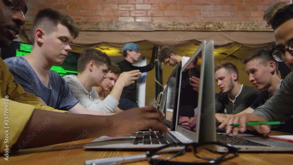 Tracking shot shot of group of young men of different ethnicities ...