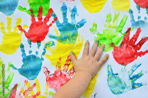 Multicolor handprint of little girl on the white background