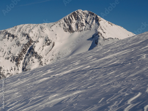 Fototapeta Naklejka Na Ścianę i Meble -  Alpine peak and glacier against blue sky