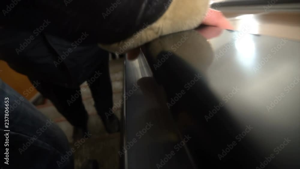 People move on an escalator,human hand on the railing. People move on an escalator,human hand on the railing.