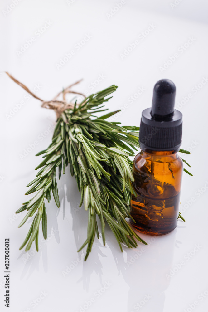 Rosemary essential oil on a white background Rosemary essential oil on a white background